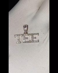 Introducing the custom varsity diamond name pendant! This luxurious, one-of-a-kind pendant is crafted with the finest materials and attention to detail. The pendant features a small gold charm inlaid with diamonds. The perfect accessory for any outfit, this pendant adds a touch of personalization.