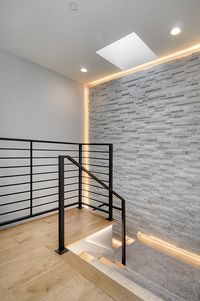 Feature Stone Wall. Staircase. Steel Stair Railing. Feature Wall in gorgeous Los Altos Home. #featurewall #staircase #stonewall #stairrail #interiordesign