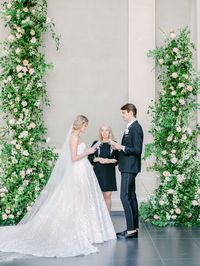 Leaf + Petal created a dramatic ceremony setup for a New Orleans garden wedding at the New Orleans Museum of Art. With blush, peach, and neutral garden roses, ranunculus, and delphinium and lush overgrown greenery, the setup beautifully framed the couple as they exchanged vows.
