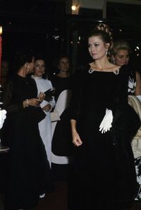 gracefilm: Inside Grace’s wardrobe… Princess Grace’s black velvet Balenciaga gown was originally displayed in the 2007 exhibit “The Grace Kelly Years, Princess of Monaco” at the Grimaldi Forum in Monaco (photo 1). The gown is full-length and slightly off the shoulder with large rosettes at the neckline. She wore this spectacular gown to the premiere of the film Grand Prix in Paris in 1967 (photos 2 and 3) and for the Scorpio Ball at the Hermitage Hotel in 1969 to celebrate her 40th birthda...