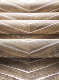 A constructed wood chevron pattern designed to depict genuine wood with detailed knots and grooves. Browse all colors at thibautdesign.com.