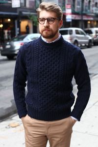 This combo of a deep blue knit jumper and camel chinos will enable you to keep your off-duty style clean and simple. Shop this look for $59: http://lookastic.com/men/looks/light-blue-long-sleeve-shirt-navy-cable-sweater-khaki-chinos/7620 — Light Blue Long Sleeve Shirt — Navy Cable Sweater — Khaki Chinos