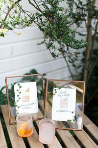 At the end of the ceremony, the chairs were cleared and guests mingled in the courtyard as they sipped on signature cocktails—a his and a hers. "We actually both love Old Fashioneds, so we used that as Jason's cocktail, and mine was gin, St. Germain, and grapefruit; I love anything grapefruit," the bride says. Marabou Designs did the illustrations and calligraphy for the signs, which were then framed on the bar with a bit of greenery.