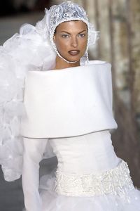 2003 Linda Evangelista walked the Fall/Winter Couture runway wearing a structural, high-neck wedding gown lace veil swimming cap.