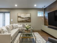 This beautiful basement renovation features an earthy colour palette, modern finishes and warm wood tones throughout. With a custom bar area, pool table and large walnut panelled feature wall this is the perfect sophistaced yet cozy family space.