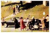 The mystery of the Babushka Lady - The mystery of the Babushka Lady - Over her hair she is wearing a scarf of a tan or light brown color — the headscarf earned her the nickname of the “Babushka Lady,” a reference to a similar Russian scarf. While she appears in several photos, probably the best and closest image of the woman is from a movie taken by Marie Muchmore, a spectator of the motorcade. Unfortunately, the mystery woman has her back to Muchmore, obscuring a clear identification