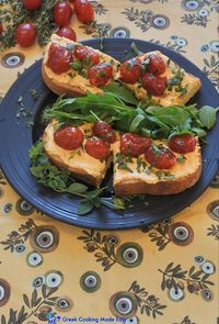 This Bruschetta has a delicious Greek taste. After the bread is toasted, the amazing, spicy Tirokafteri (or tyrokafteri) dip & mini tomatoes prepared as confit are spread on top for a wonderful sweet & tangy combo. #μπρουσκεταμετυροκαυτερη #bruschetta #greekbruschetta #greekcooking #therecipeoftheday #syntaghthshmeras #keepcooking #greece #greek #greekrecipes #monoxeria #delicious #συνταγες #greekcookingmadeeasy #greekblogger #foodinspiration #likemygrandma #ελληνικηκουζινα #mediterraneanstyle