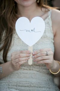 For summer weddings, your guests might need a little help staying cool during your wedding ceremony. One of the most popular wedding program ideas is affixing a traditional program to a wooden handle to create a fan.