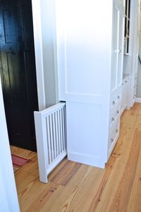 When customizing our cabinets, we worked with our cabinet builder to create a built-in hidden dog gate, perfect for our family!