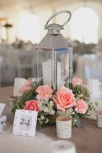 lanterns with flowers around the base for centerpieces. (not necessarily these flowers.)