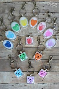 Thumbprint Heart Keychains - A unique handmade craft and gift idea that kids and adults can create. Use this easy fingerprint heart charm tutorial to make one-of-a-kind hanging heart keychain charms your family will treasure. The perfect gift for Mother's Day, Father's Day, Christmas, a birthday or Valentine's Day! | #ValentinesDay #GiftIdea #KidsCraft #MothersDay #FathersDay