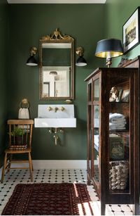 Vintage furniture in a bathroom can be just completely gorgeous! I love the deep olive green too.