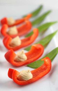 Colorful cut veggies with a dollop of hummus.