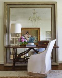 ASHLEY GILBREATH INTERIOR DESIGN: The oversized mirror and vintage desk are the perfect combination for an elegant master bedroom.