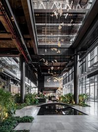 A refreshing take on Beijing architecture, constructed within the remnants of an abandoned 20th-century industrial building, taking advantage of the reimagined urban landscapes and industrial ruins created by China’s economic reforms of the 1990s. The Main Building is enveloped in an elaborate glass façade that acts as a ‘transparent skin’. It wraps around the original industrial components, such as concrete walls and steel roof trusses, which are left exposed in all their utilitarian glory.