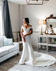 Vintage Off-the-shoulder Mikado Wedding Dress Josie by Rebecca Ingram. Click to find this gown! . . . . #vintageweddingdress #offtheshoulderweddingdress #mikadoweddingdress #satinweddingdress #fitandflareweddingdress