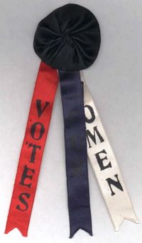 Suffrage Rosette with Ribbon Tails Imprinted with the Phrase "Votes For Women" (1915)