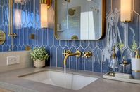 Stunning Blue Settecento Crayons tile with Brass Hardware. Light Gray countertops. White shower. #masterbathroom #bathroom #bathroomideas #bluetile #brasshardware #bathrooms #bathroominspiration #sconces