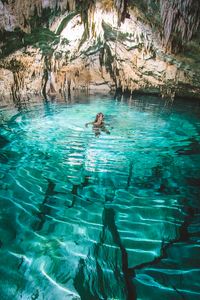 Alien caves? Nope, just an underground cenote in Tulum, Mexico // If you're looking for some awesome and unique places to travel in Mexico, check out our cenote guide. We cover all the best cenotes to visit in Tulum, Cancun, Riviera Maya, Valladolid and more!