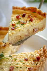 Classic Quiche Lorraine with a savory egg custard, bacon, and cheese filling in flaky pie crust. Quiche Lorraine is the gold standard of quiche recipes! Perfect breakfast and brunch food. #quiche #quicherecipe #quichelorraine #howtomakequiche #piecrust #savorypie #natashaskitchen