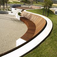 This contemporary curved bench seat in the landscape is so smart. Can you imagine relaxing and kicking back in the afternoon sun. The form would also work well with exposed aggregate concrete. If done in this treatment it would then double as a skatepark with a deck and ramp. This form would also work well in a school environment where the teacher could take an outdoor class. Critic by John Dodd L'scape Arch.