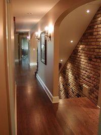 Basement entrance... gorgeous. Love the lighting and brick wall.