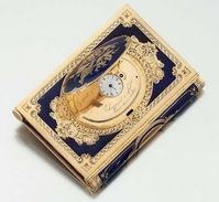 Gold and Enamel Dance Card with Concealed Watch, c.1850. An actual dance card is typically a booklet with a decorative cover, listing dance titles, composers, and the person with whom the woman intended to dance. Typically, it would have a cover indicating the sponsoring organization of the ball and a decorative cord by which it could be attached to a lady's wrist or ball gown.