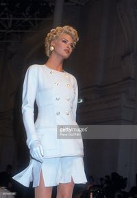 French design house Chanel shows its women's 1991 spring-summer haute couture line in Paris. Model Linda Evangelista, sporting blond curls, is wearing a classic pale blue suit.