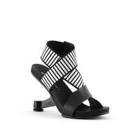 The Eamz Sandal is a slip on sandal with a strappy upper. The silicon printed elasticized straps and molded leather footbed offer a comfortable fit. The heel is inspired by the classic Eames lounge chair - an icon of Modern design. Standard Fit Heel Height: 100mm/4in Nappa leather and elastic upper Leather lining Rubbe