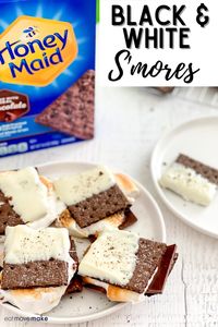 Black and White S’mores - the perfect summer dessert! #ad Ooey-gooey toasted marshmallows and melted chocolate with dipped chocolate @honeymaidsnack graham crackers. Put this on repeat! It’s a fun and delicious twist on a traditional smores recipe. #smores