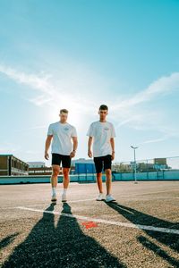 WEDAMNZ MERCHANDISE aesthetic men walking with a sunglass and a white creative shirt and text Poses for men, ideas, business, aesthetic, walking Creative photography ideas with a lot of color, orange and teal for a clothing brand Influencer, Instagram, content creator, content creative, creative photography Men fashion, men clothing styles, streetwear fashion