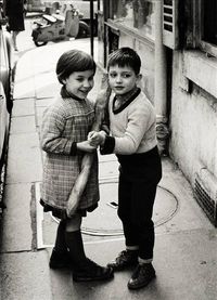'Brother & sister coming back from a bakery with a baguette, Saint-Germain-des-Prés, Paris', by Harold Chapman