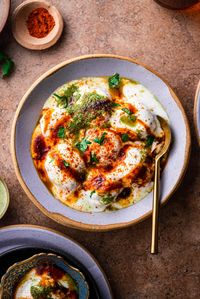 Dahi Vada, or Dahi Bhalla Chaat, is soft lentil fritters that are deep fried and served with dahi, chutneys, and spices to make chaat! It's a delicious appetizer or a side dish to accompany a meal at parties or Indian festivals.