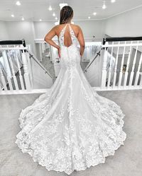 This halter neckline beach wedding dress is perfectly tailored for easy, breezy, and summery-chic celebrations! Click through to see if it's the dress for you! #halterweddingdress #lacebridalgown #beachbridaldress