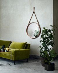 When put with darker greys and more muted tones, olive shades can bring a dark and moody atmosphere to a room.
