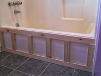 Basically we built a frame for the front if the tub and covered it with beadboard wainscoting and MDF moldings (a plastic, waterproof, rot proof version of the classic wood moldings). On the top edge of the tub we placed a board made from PVC to finish off the built-in look. We also added MDF boards on the side of the tub going up the wall to further anchor it in place. What is behind a beadboard trim to update and upgrade old bathtub