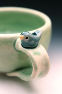 Back by popular demand! Custom Made Handmade Pottery Bird Cup by Tasha McKelvey. 3-5 Weeks for delivery in the U.S. Little glazed mug with a sweet little bird on it. Available in four color combinations. Made of High-Fired White Stoneware Clay. Microwave Safe - Dishwasher Safe, but