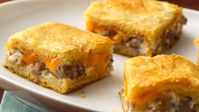 Sausage and two kinds of cheese turn crescent dough into a rich and tasty appetizer.