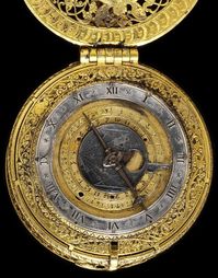 clock watch of cast and pierced engraved gilt brass with a silver dial, designed to strike the hours. Decorated back and front with engraved scenes of Abraham preparing to sacrifice Isaac, the dial showing the age of the moon, days of the month and hours. The movement is signed 'T. Chamberlin fecit'.