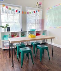 This is the cutest classroom table and so simple to build too! It would also make a great desk or table for home! You can build the entire thing for under $100 in materials! Come check out the free plans!