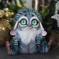 "Welcome to Nafantano! Meet the fantastic beast, Teal Buleon! It is a \"Buleon\" because it's inspired by the morphing together of the sweet floppy ears of a bunny (bu), the wild eyes of a lemur (le) and the distinctive spotted coat of an oncilla (on). Like all of my wonderful and unique creatures, it is meant to be cute with a touch of eerie mystic. The Teal Buleon is noted for its mesmerizing sea foam eyes and its teal and black striped coat and fur body. I'm Nafantano - a self-taught artist w