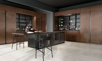 Base cabinets fronts: Heat treated madera oak and black aluminum frame smoked glass | tall cabinets fronts and above columns: Copper oxidized liquid metal | Snack table: Heat treated madera oak | Worktop: Dekton | Groove and plinth: Urban