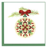Send holiday greetings with a quilled Ornament Christmas Card! Decorating the tree with unique ornaments is a holiday tradition for many families. This card can become a lasting holiday decoration when paired with one of our shadow box frames! The paper art design depicts a round cream colored ornament with a unique red and green abstract design on it. The ornament hangs from a printed tree branch with a quilled red ribbon at the top. Don’t just send a card, send art!Certified Fair Trade Federat