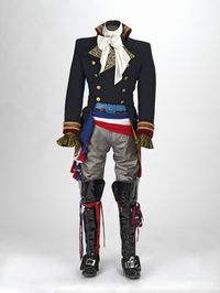This is one of Adam Ant's performance costumes known as the "Prince Charming" costume. The costume was made in 1981 and is housed at the Victoria and Albert Museum. The costume was made by Adam Ant, Charles Davis Whiteing, Yvonne Swinden, and David Lewis. The military jacket is made of wool, satin, furnishing fabric, gold braid and metal buttons.