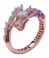 Elegance rules with this Enchanting Petite Rose Gold Dragon Ring featuring Micro Pave with colorful details Material: Pave Pave Cubic Zirconia and Purple Enamel Surface Width: 0.23" petite ring Setting Type: Tension Mount Photos are enlarged to show details