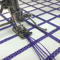 Adapted from a hand embroidery technique, couching is a simple way to add color and texture to a project, stitching yarn, cord, or fibers to the surface of the fabric. #sewing #tip #decorativestitch