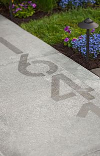 For a new approach to house numbers, apply Rustoleum's NeverWet to your sidewalk. When dry, the house numbers are subtle, but they really stand out when coated with rain.