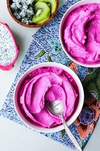 Dragon Fruit Smoothie Bowls / This delicious vegan and paleo breakfast bowl is similar to nice cream - made by processing frozen dragon fruit, mango and bananas, and then topped with fresh fruit, nuts, and coconut.