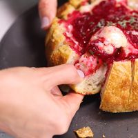 You have to try this! For your Thanksgiving, Christmas and any holiday parties, try this elegant easy 3 ingredient baked brie cranberry in a pull-apart bread bowl for dipping! #RecipeVideo #FoodVideo #Video #Thanksgiving #Christmas