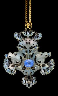 René Lalique - An important Art Nouveau gold, enamel, moulded glass and Ceylon sapphire pendant. Centring upon an oval-shaped sapphire with moulded glass greyhounds and two-headed snakes curled around an enamelled foliage in various shades of blue, mounted in gold. Signed.